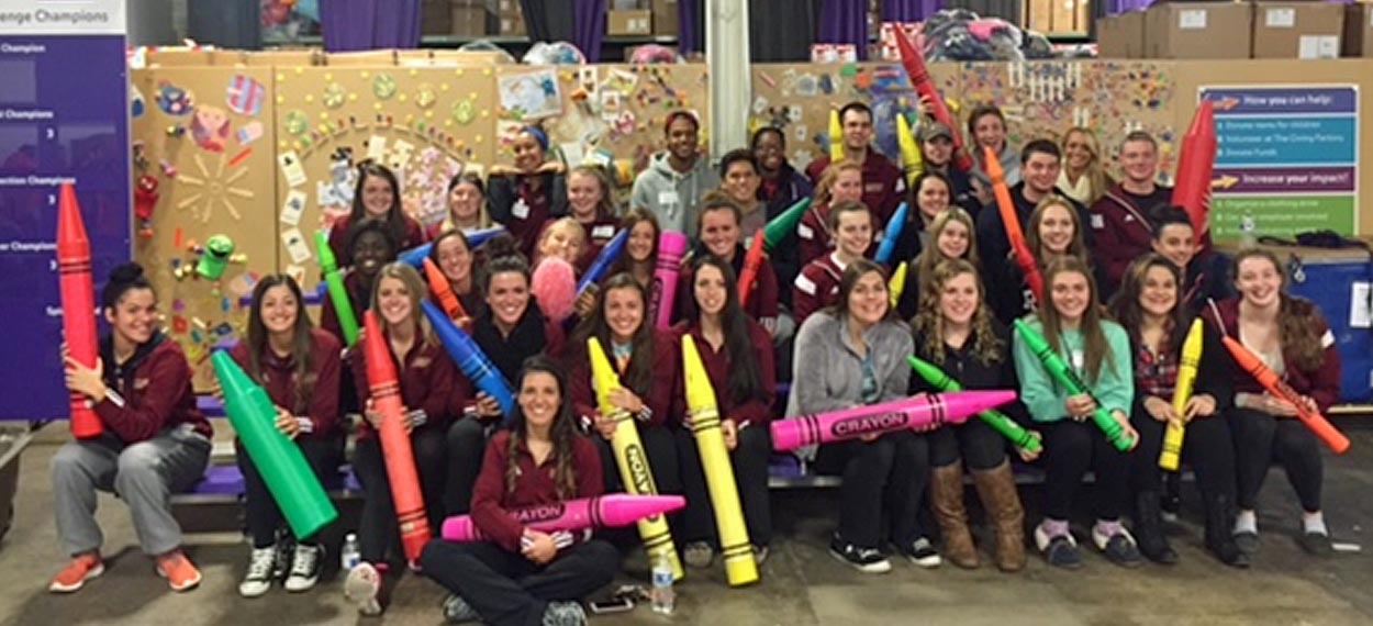 REGIS SOCCER AND SWIMMING HELP OUT AT CRADLES TO CRAYONS